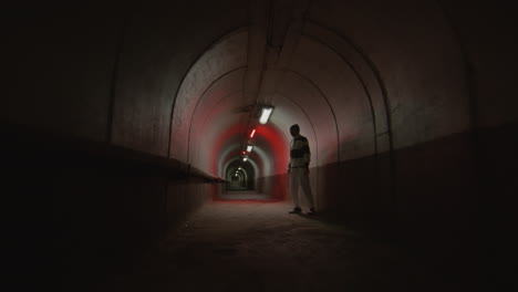 parkour athlete doing side flip off tunnel wall