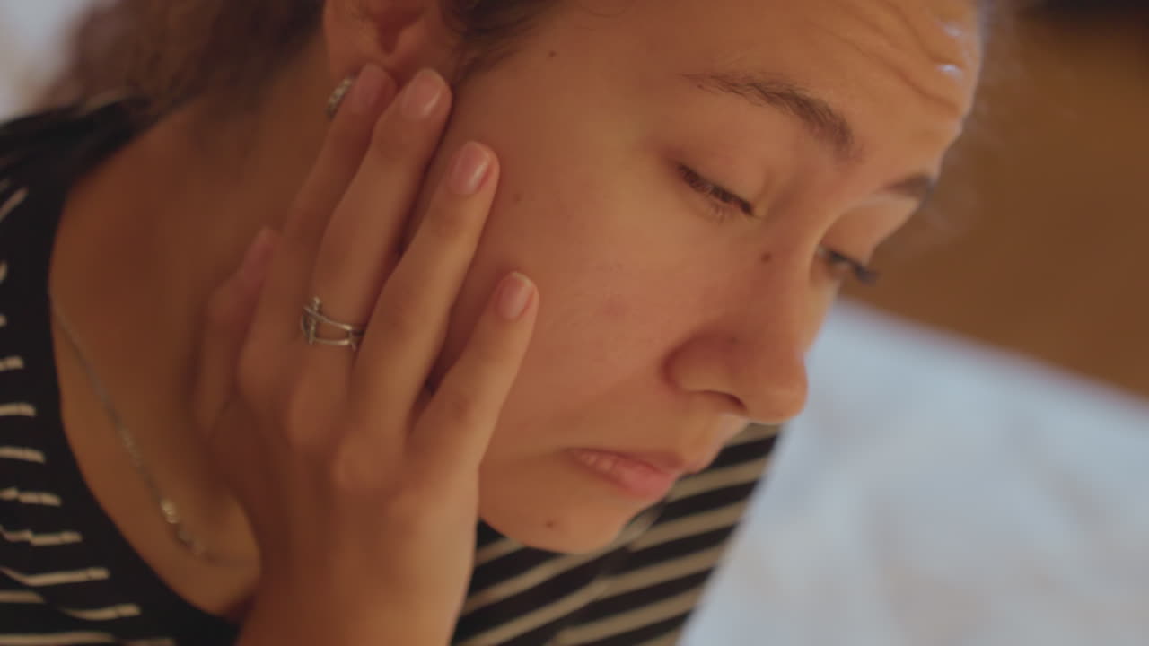 Jetlag causes clear fatigue in young woman. Young woman appears distinctly tired from travel stress. Exhaustion from travel is obvious as young woman displays visible signs of fatigue
