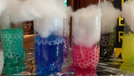 Kids-Science-Lab-background-made-out-of-2-liter-soda-bottles-cut-in-half-filled-with-different-colored-aqua-beads