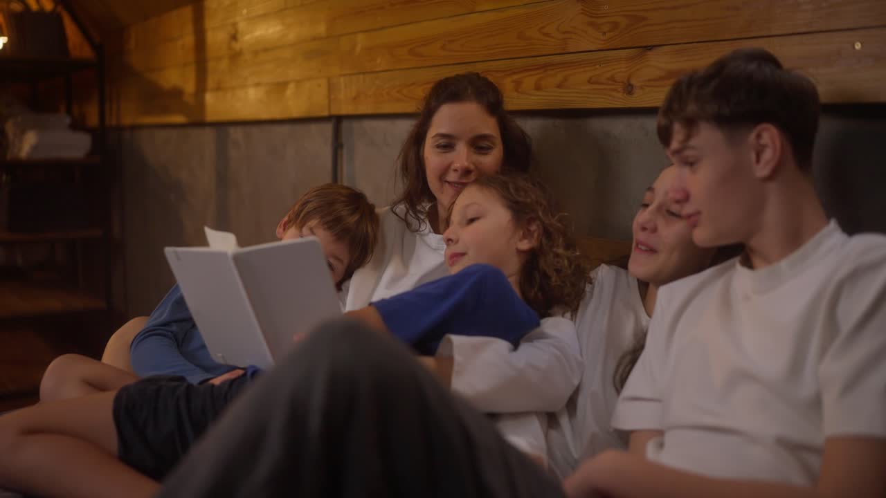 Mother and Children Reading a Story in a Cozy Attic Bedroom