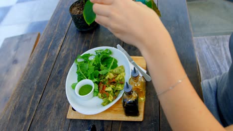 Woman-photographing-salad-on-the-table-4k