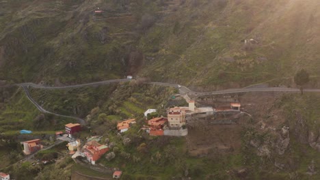 Drone-shot-of-an-car-driving-on-a-street-in-the-mountains