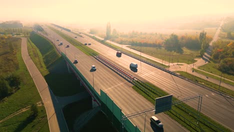 beautiful top side view to the cars driving on multi-level highway on the sunny evening in warsaw picturesque aerial panorama of the road traffic and sunset city