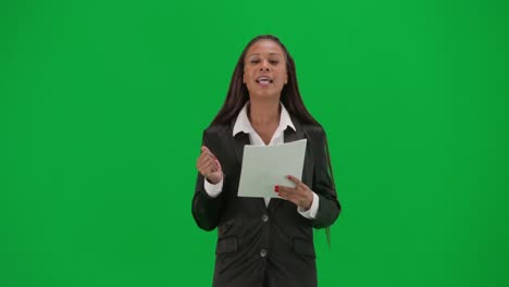 woman presenter reading a document on green screen