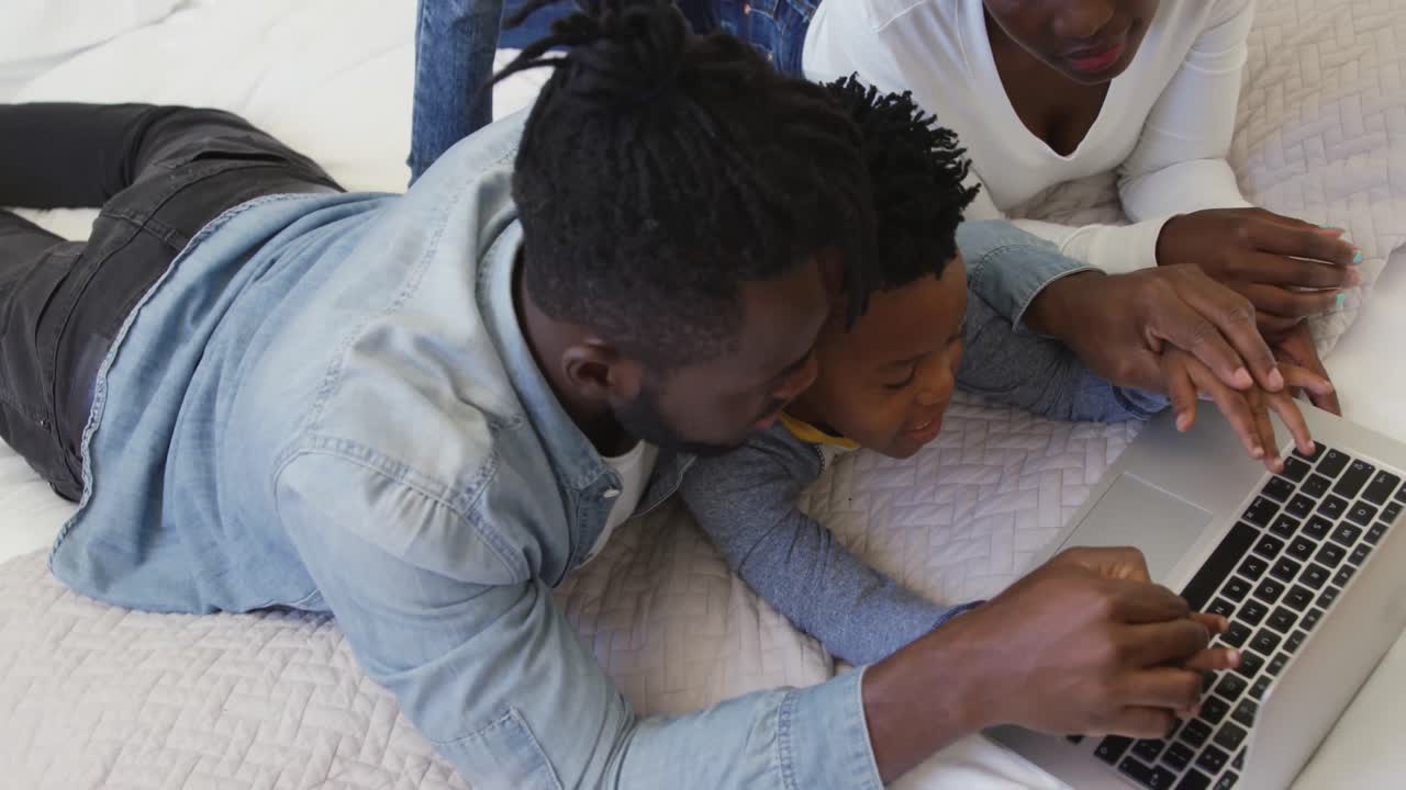 Family using laptop together at home