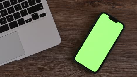 smartphone mockup green screen on freelancer's work desk