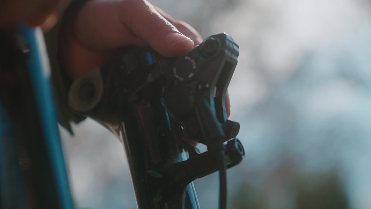 Close-up of a Person Adjusting a Shimano Mountain Bike Brake