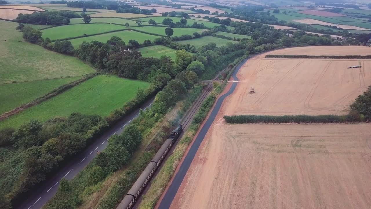 Aerial View of a Steam Train Traveling Through the Countryside
