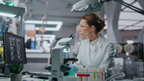 biochemistry specialist checking samples in beaker working in laboratory closeup