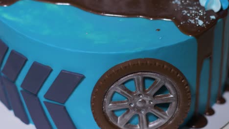 blue children's cake with car wheels