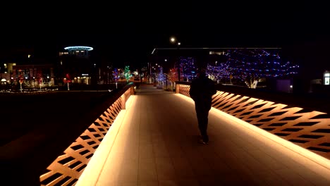 man walking in the street at night