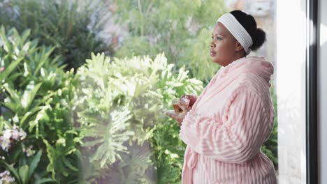 African-american-plus-size-woman-drinking-tea-at-spa,-unaltered,-copy-space,-slow-motion