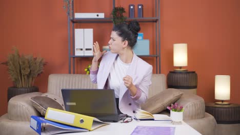 home office worker young woman looking nervously at camera.