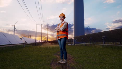 full body side view of asian female engineer with safety helmet crossing her arms and looking around with solar panel and wind turbines