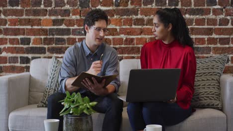 man and woman working together in office