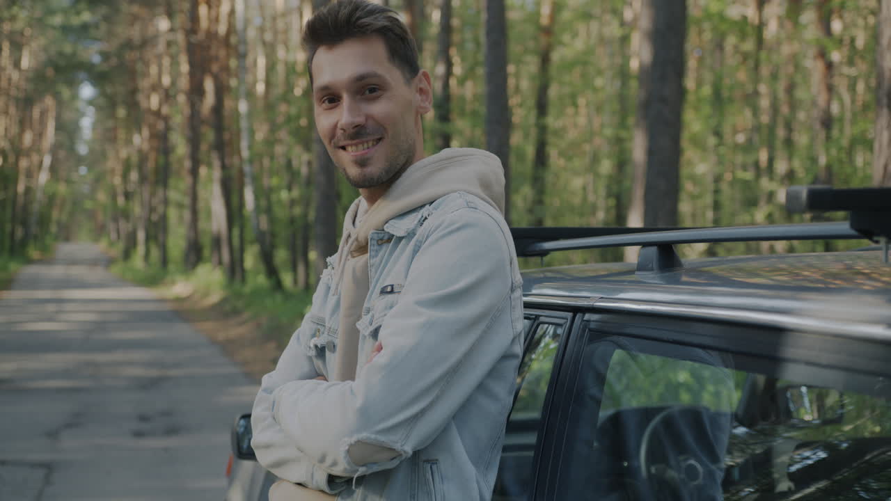 Man by Car in a Forest