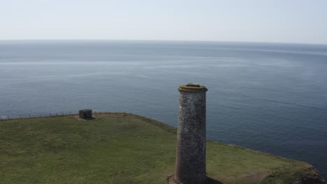 endless expanse of blue ocean water beyond old brick navigation tower