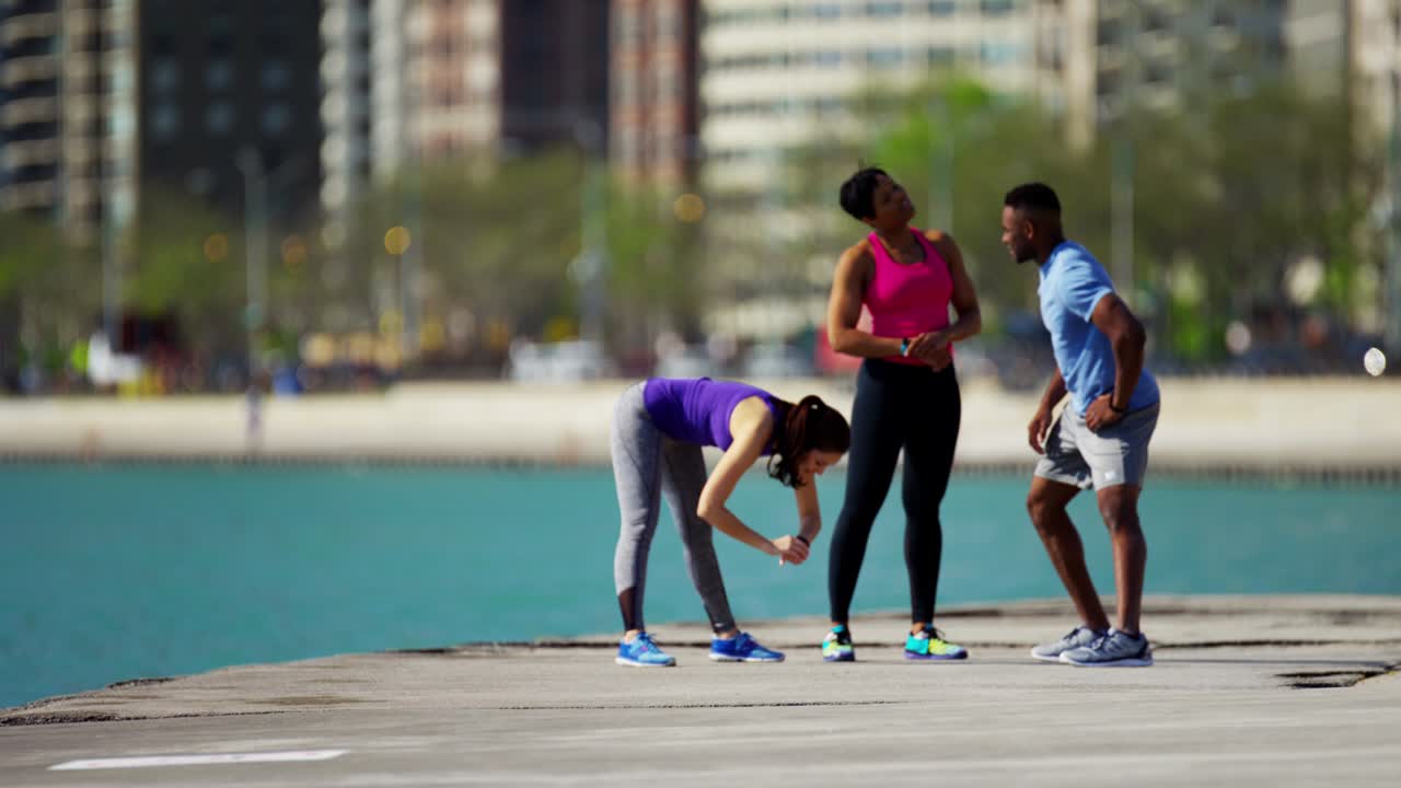 Multi Ethnic male and females fitness stretching outdoors