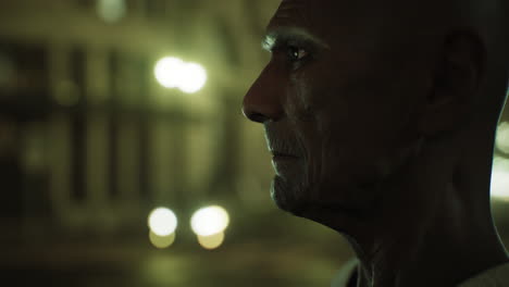 old-asian-man-in-big-city-at-night