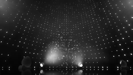 dark stage with spotlight and particles