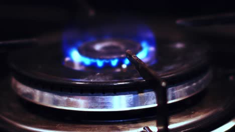 close up top view of igniting a gas cooker with a bright blue flame