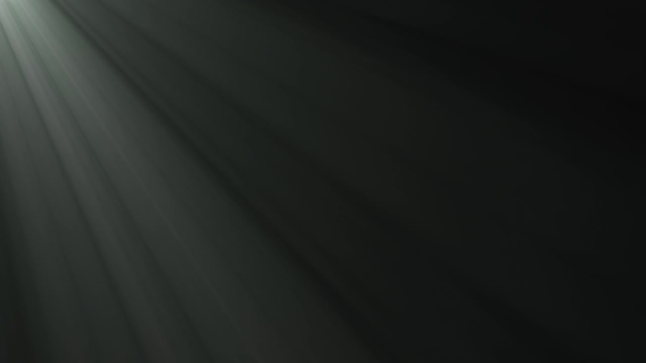 Soft White Light Rays Shining Through Dark Background