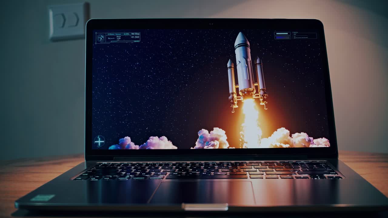 Close-up angle of a laptop displaying a rocket launch video. The scene is dynamic and futuristic