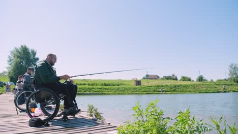 man with disabilities fishing at a lake. wheelchair. camping. summertime