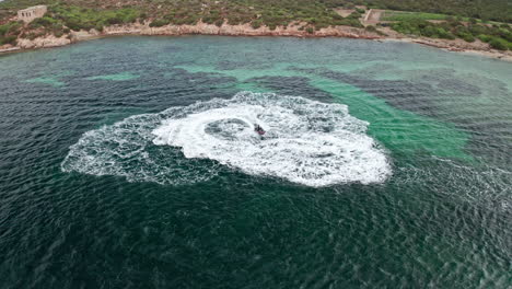 jet ski creates swirling patterns in the turquoise waters near sardinia