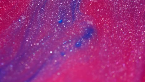 abstract ink mixing, macro shot with glittery paint details and vibrant colors blending