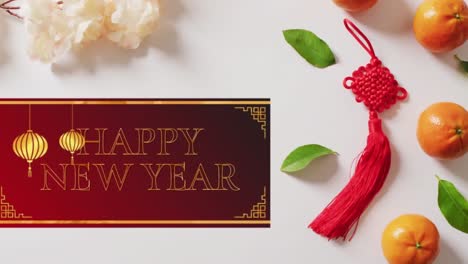 Animation-of-new-year-greetings-text-over-chinese-traditional-decorations-on-white-background