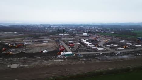 Arcing-shot-revealing-housing-plots-surrounded-by-heavy-machinery-on-a-site