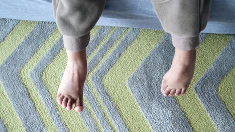 child's feet on a carpet