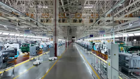 Close up view robot arm inspecting an automobile assembly line works in a factory that assembles lithium or sodium batteries used in cars or electric vehicle