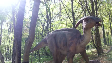 a mockup of a baby dinosaur stands in the middle of the forest and shakes its head a mockup of a baby dinosaur stands in the middle of the forest and shakes its head dinosaur park back to the past