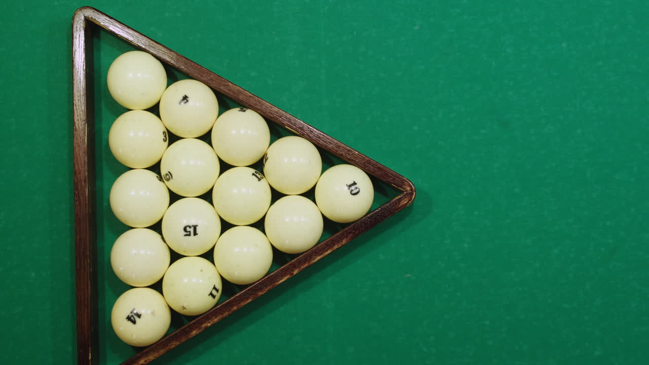 Beginning of game white pool balls top view on green billiards table for start to play. Russian biliard game, Russian pyramid. Billiard balls with numbers on a pool table. Billiards team sport.High quality 4k footage
