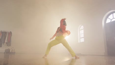 portrait of caucasian female dancer dancing in dance studio, slow motion