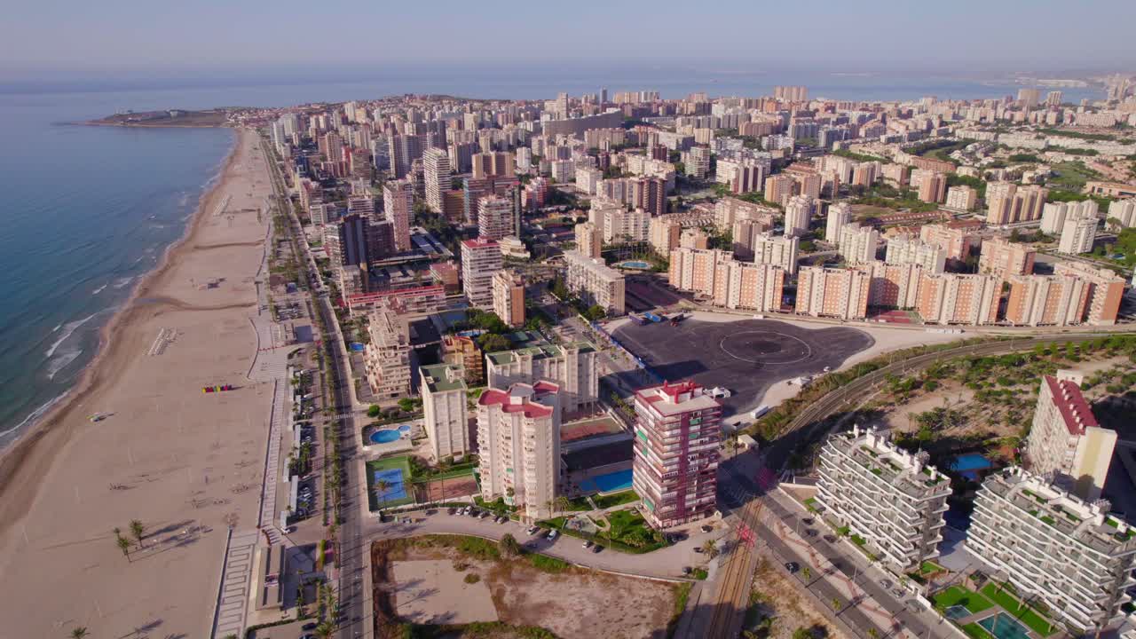 panoramic aerial of San Juan Playa beach with residential buildings at sunrise in Alicante, Spain