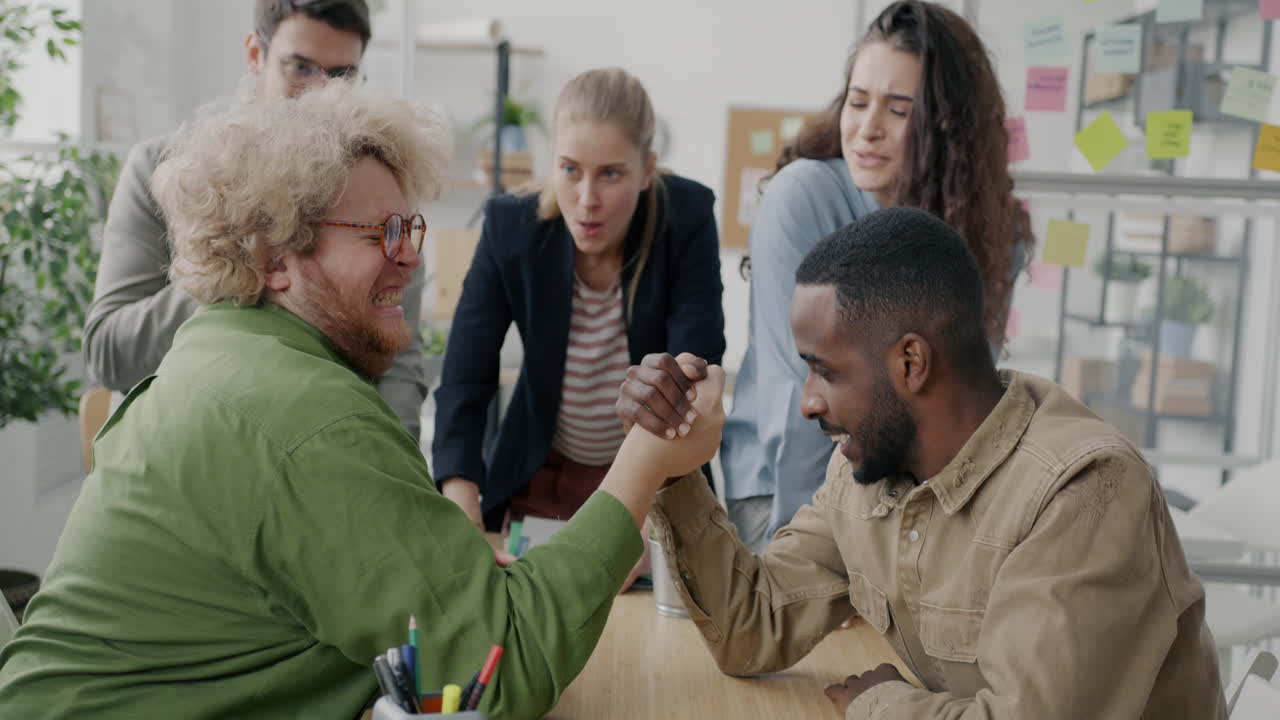 Teammates Arm Wrestling in Office