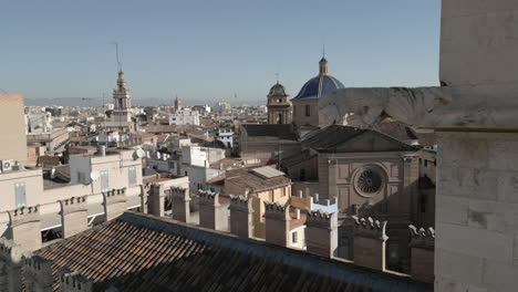 Drone-Shot-of-Gargoyle-with-Cityscape-in-Valencia,-Spain