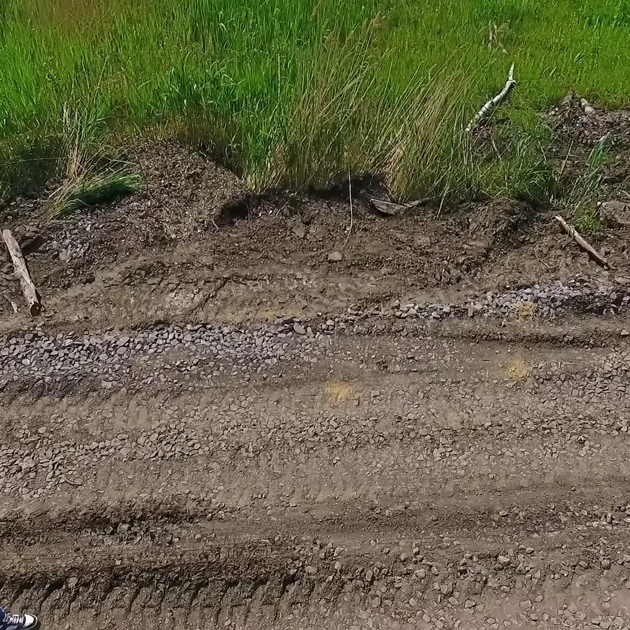 Engineer in orange helmet walks. Technical expert is walking to the construction of a new solar power plant on the field. Top view.