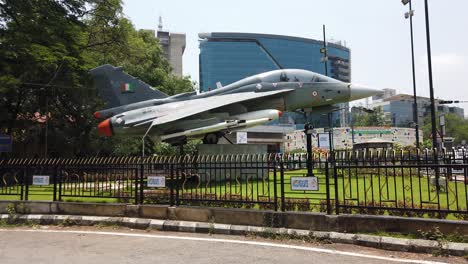 pan shot of a display of indian air force fighter jet tejas on the main road of bengaluru city