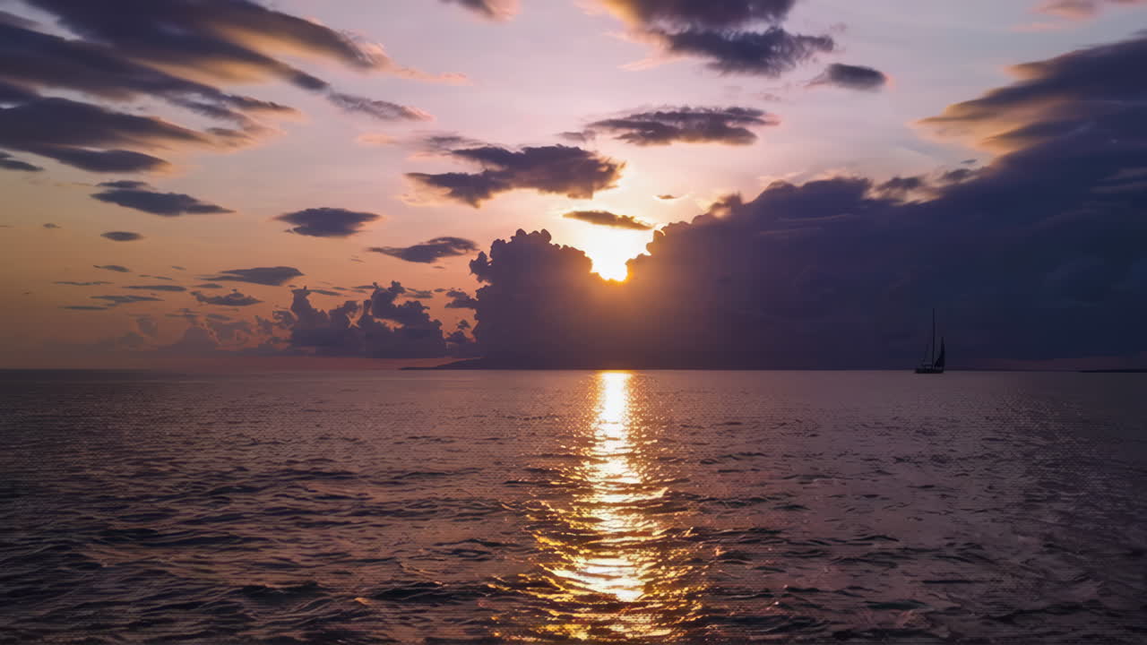 Sunset over the Ocean with Sailboats