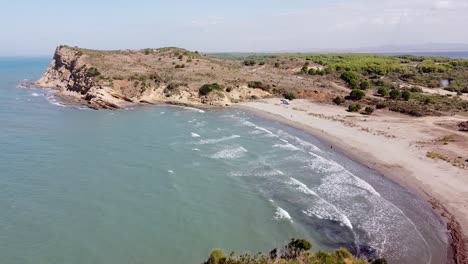 people playing at porto novo beach, zvernec, albania - aerial drone view