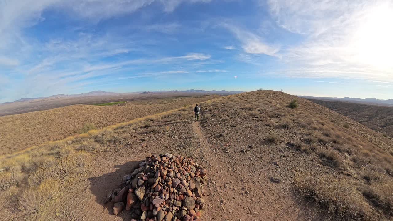 Male hiking with a backpack in the McDowell Mountain Regional Park.