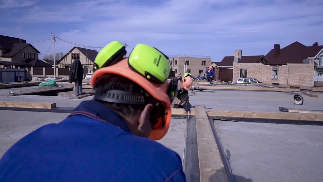 Construction Workers Assembling Roof Structure