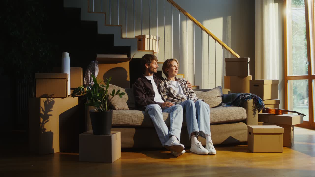 Couple relaxing on sofa during a move