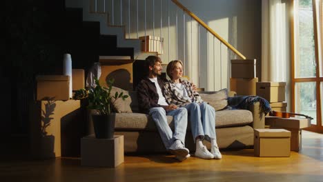 couple relaxing on sofa during a move