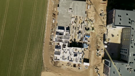 Top-View-Of-Construction-Site-With-Tower-Cranes-In-The-Town-Of-Lubawa-On-A-Sunny-Day