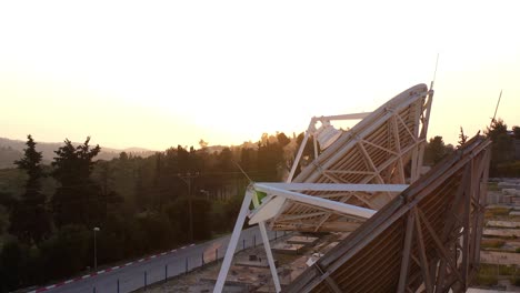 satellite dish at sunset over hills